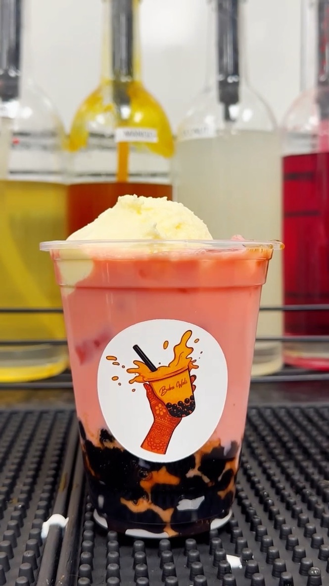 Pink rose drink topped with cream